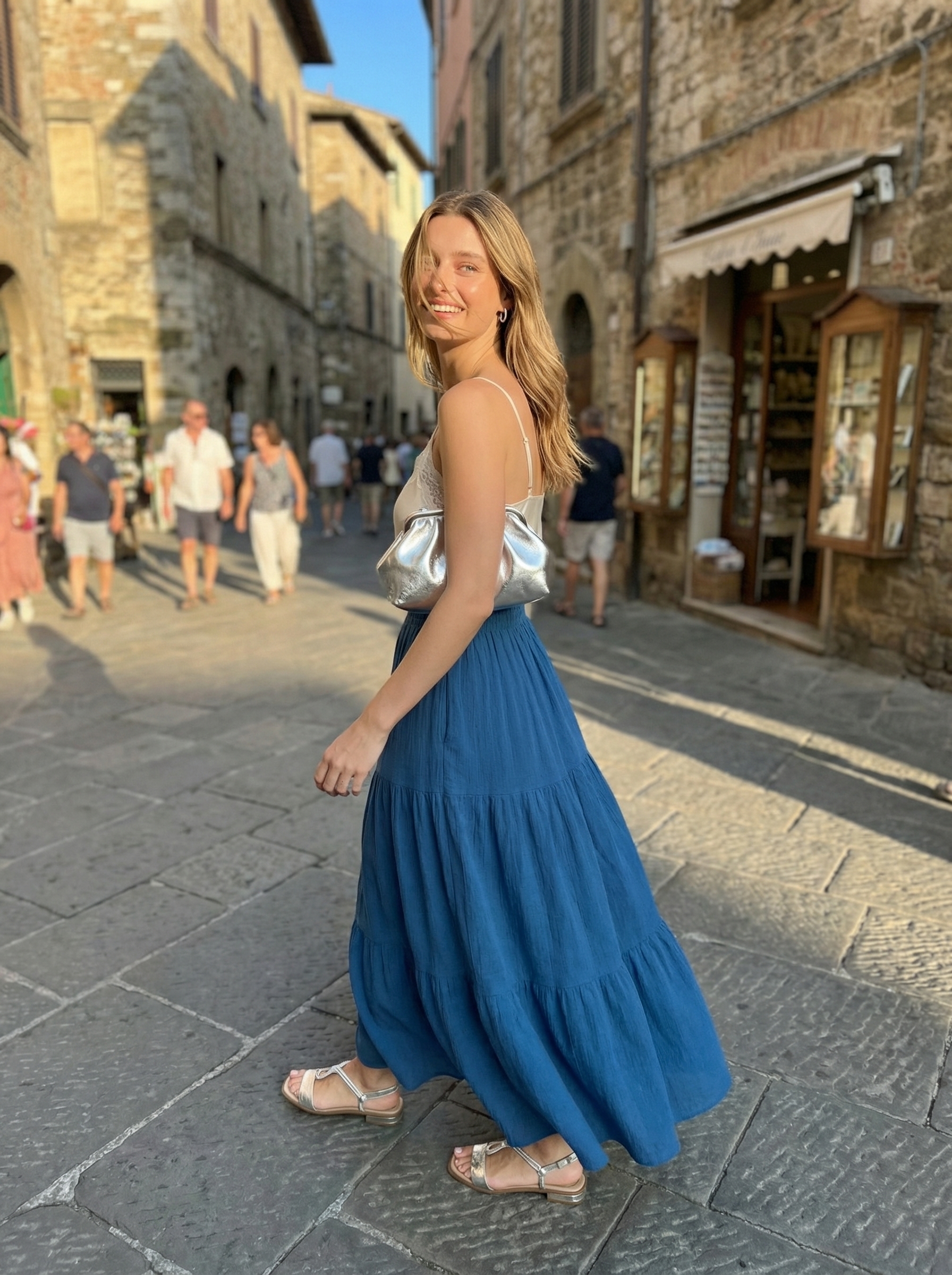 Elegant cobalt blue tiered maxi skirt and white camisole with silver accessories – a glamorous Europe summer outfit for evening dinners.